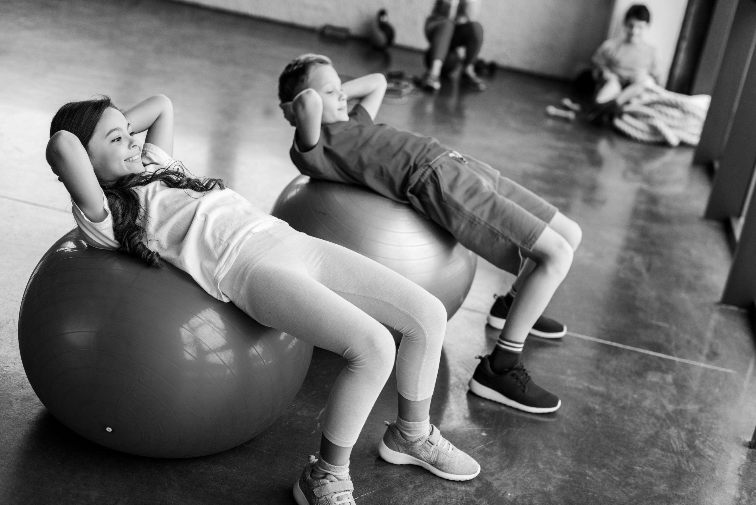 BW-kids-doing-abs-exercise-with-fitness-balls-2021-08-31-13-50-44-utc